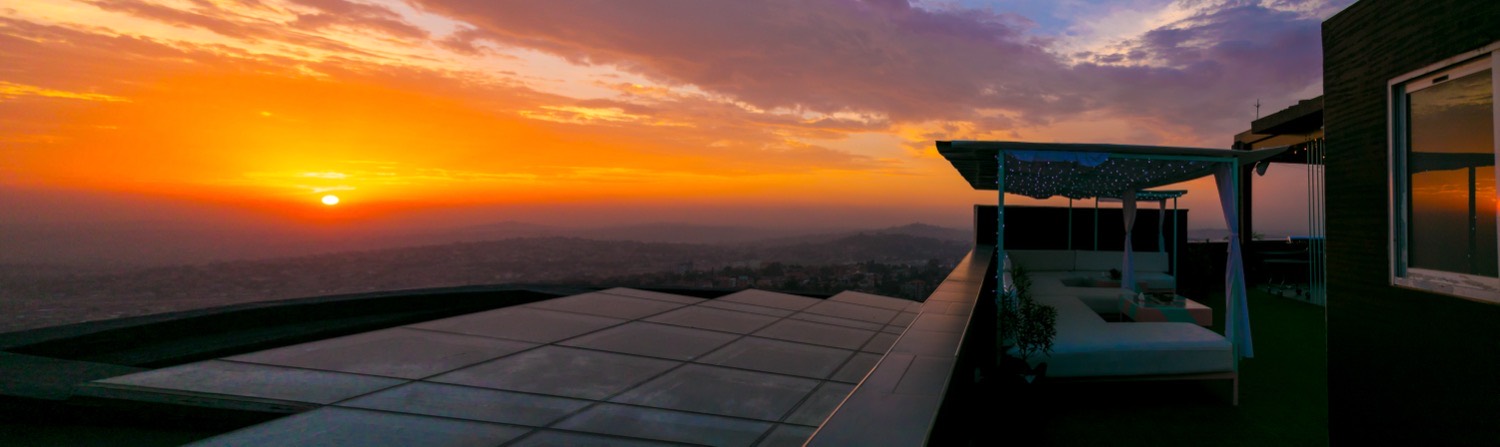 Rooftop terrace daybeds at golden hour