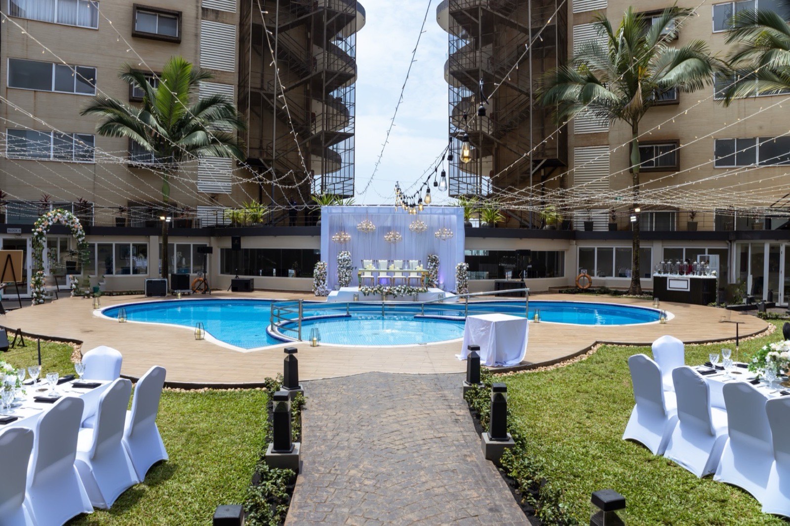 A wedding ceremony setup beside the twin pools at Tropicanna Poolside, Skyz Hotel Kampala